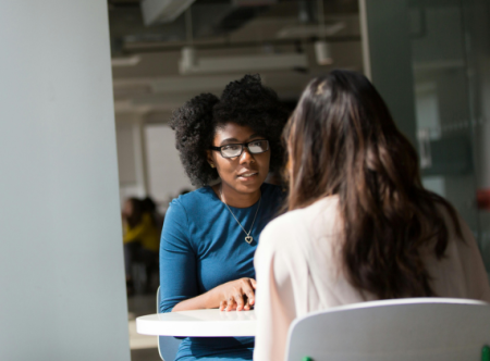 Two women talking across a table Pexels.com 1181712.jpg