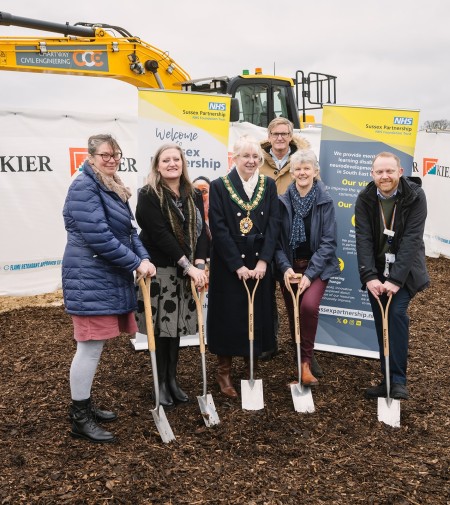 The team standing on the ground with spades in their hands at the breaking the ground ceremony in Bexhill. 