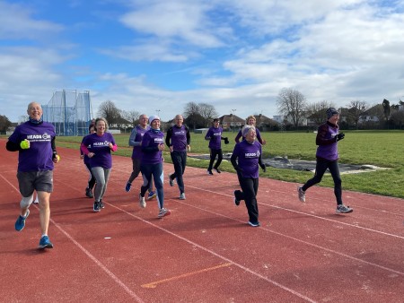 Heads On running club members on the track